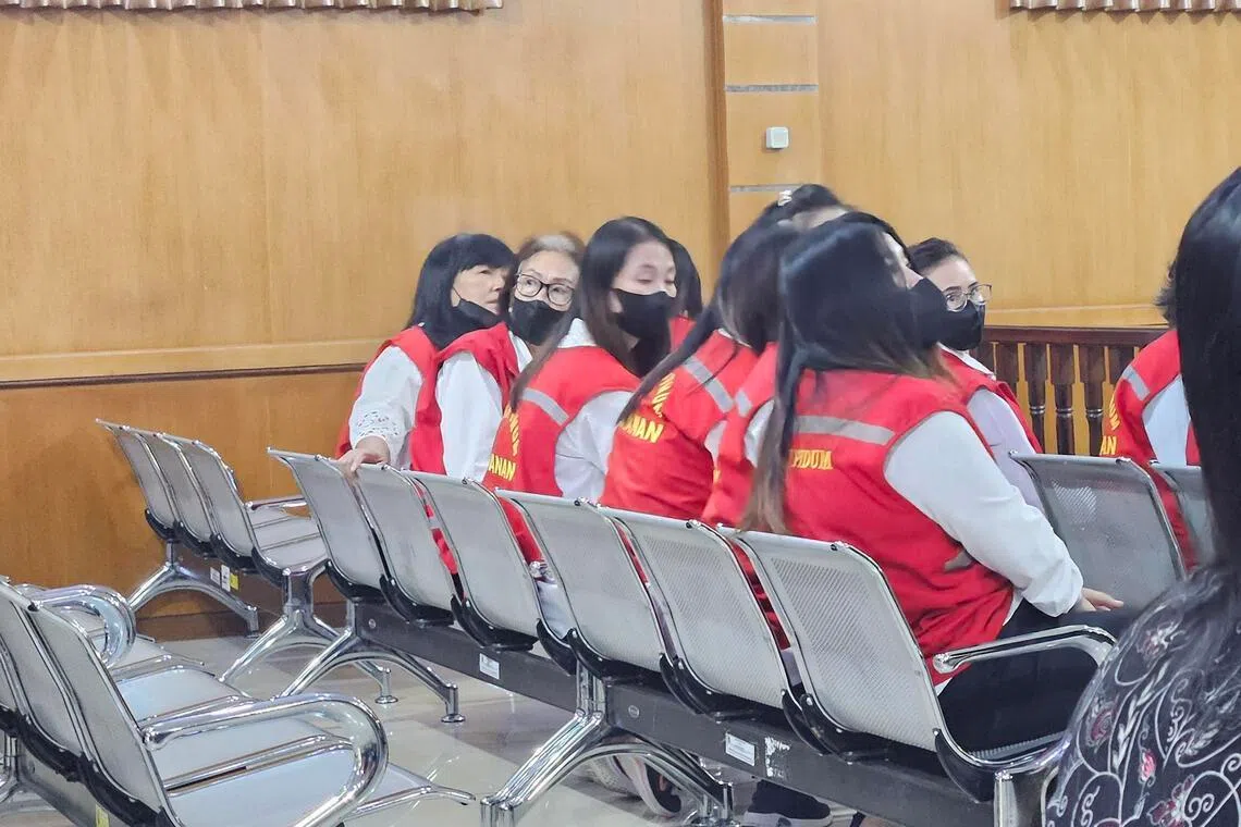 Lie (second from left), described as the ringleader of the traffickers, in a courtroom at Bandung District Court, West Java.
