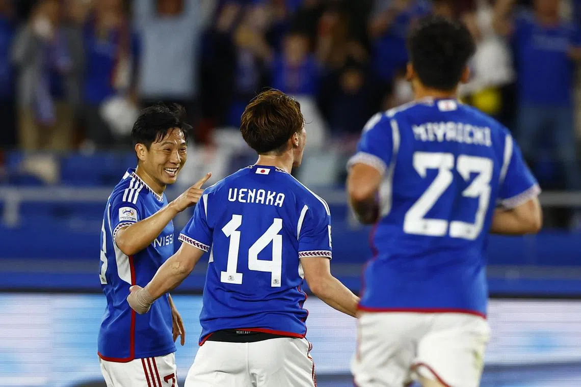 Yokohama F Marinos' Asahi Uenaka celebrates scoring their first goal with teammates.