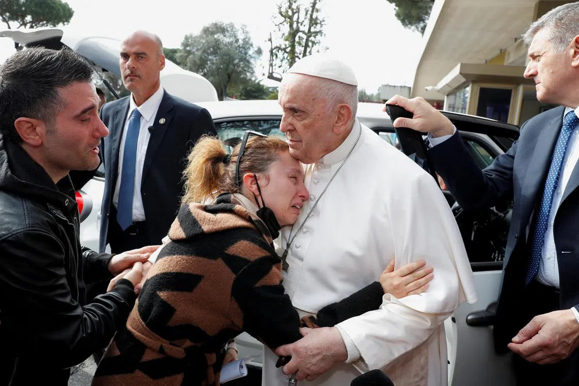 Ms Serena Subania hugs Pope Francis. Her five-year-old child Angelica died at the Gemelli Hospital, where the pontiff was treated for bronchitis.