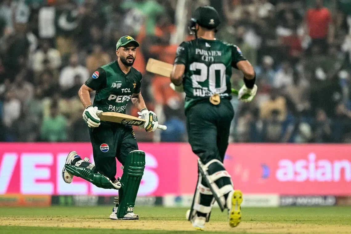 Pakistan's Mohammad Nawaz (left) and Hussain Talat run between the wickets in the Asia Cup Super Four Twenty20 cricket match against Sri Lanka at the Sheikh Zayed Cricket Stadium in Abu Dhabi on Sept 23, 2025.