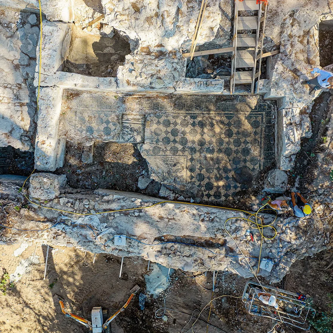 A worker cleans a mosaic floor uncovered during archaeological excavations at Villa Celimontana in Rome, Italy, in this handout image taken on July 30, 2026 and released on August 5, 2026. Rome's Special Superintendency/Handout via REUTERS.