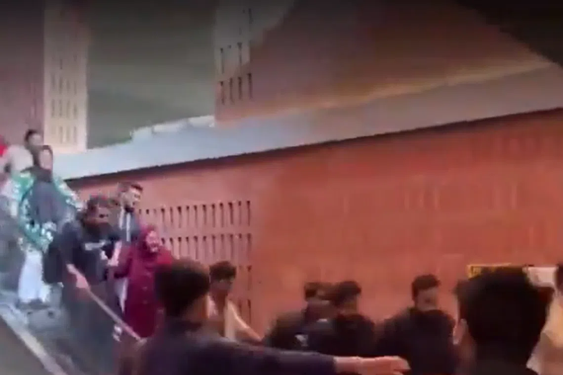 A screengrab shows students at BRAC University in Dhaka stumbling and grasping at the handrails of an escalator that suddenly surged forward.
