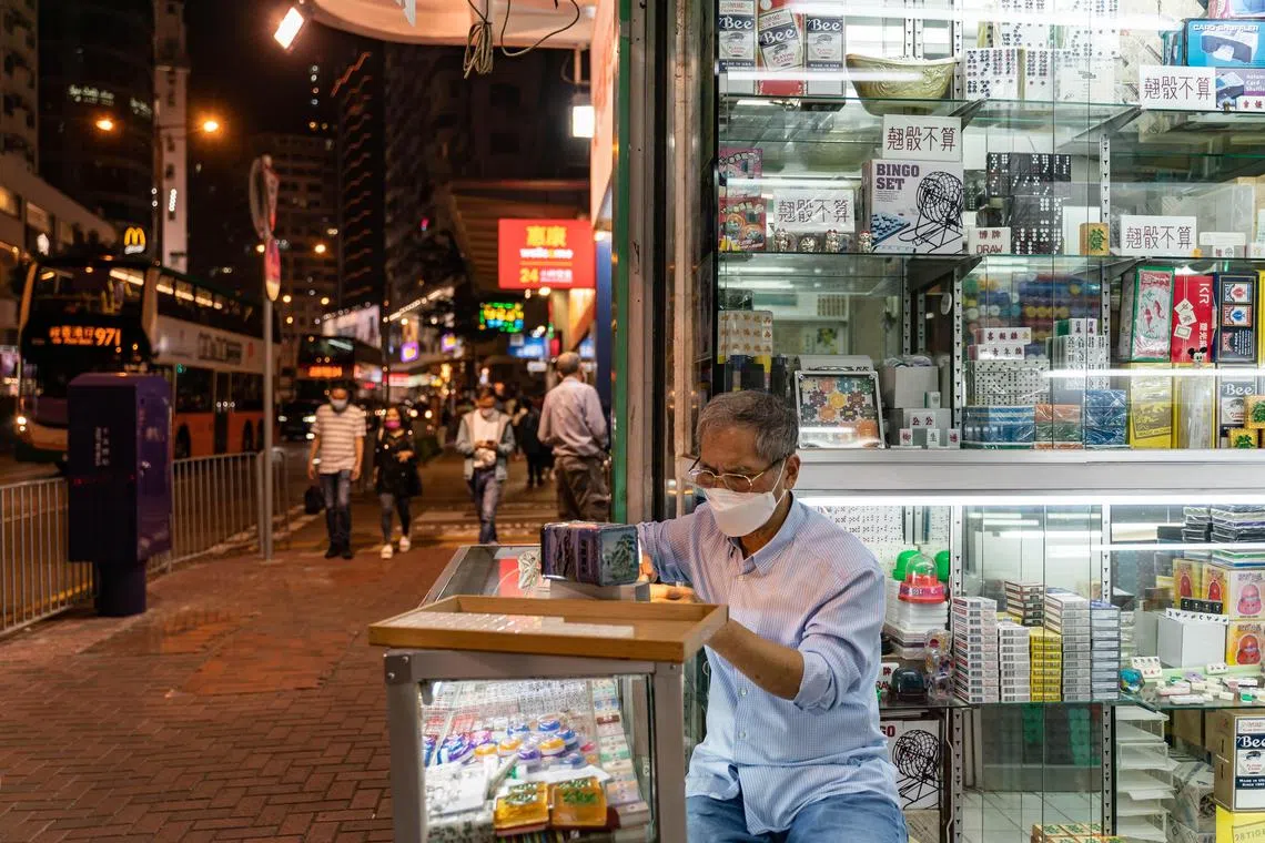 Mr Cheung Shun-king engraves a mahjong tile in front of his shop, Biu Kee Mahjong, in Hong Kong on Nov 13, 2022.