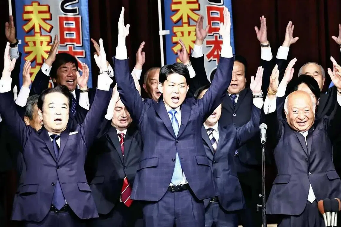 LDP candidate Nobuchiyo Kishi (centre) celebrates after it was certain that he would win the by-election for Yamaguchi second district on Sunday.