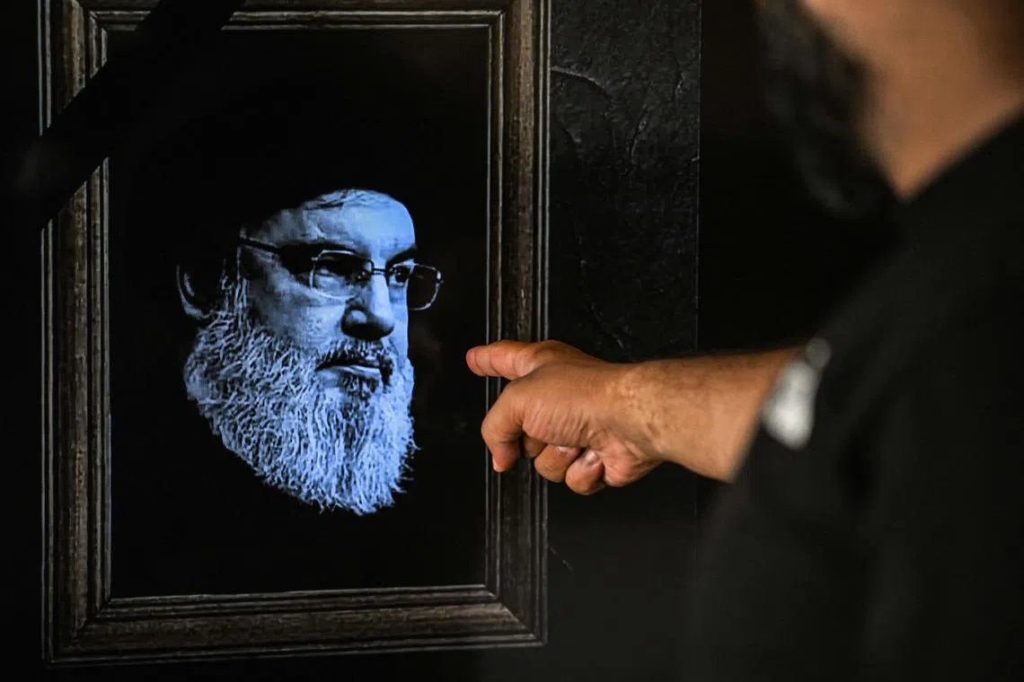 A TV showing an image of late Hezbollah leader Hassan Nasrallah, during a broadcast by Lebanese station NBN, in Beirut, on Sept 28.