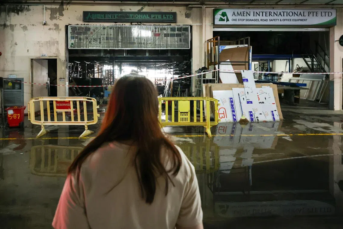 ST20240920_202406600146/zyfire20/Brian Teo/Zaihan Mohamed Yusof/Ms Vina Thai, 31, Wife of the Owner of 93 Motorsports, standing outside the Amen International Pte Ltd office at Synergy@KB Kaki Bukit on September 20, 2024. 93 Motorsports is on the right of the Amen International Pte Ltd office. ST PHOTO: BRIAN TEO.