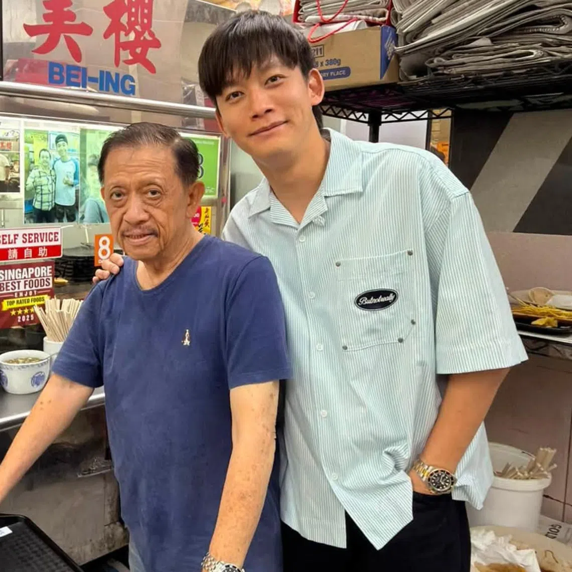 Singapore actor Noah Yap (right) with hawker Yeo Song Khoon, who was pushed to the ground after he patted a girl’s head.