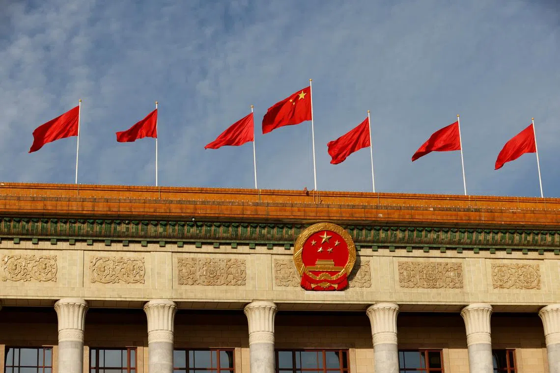 FILE PHOTO: A Chinese flag flutters on top of the Great Hall of the People, in Beijing, China October 18, 2023. REUTERS/Edgar Su/File Photo