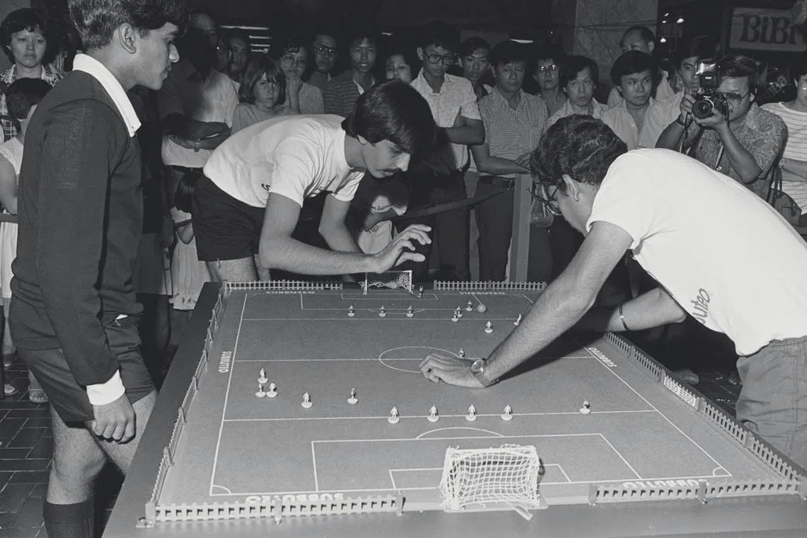 200 contestants took part in the Singapore national Subbuteo championship held at Plaza Singapura. The first national Subbuteo champions, C Chandru, 21, and schoolboy Teng Lip Chiang, 14, who emerged the winners will represent Singapore in Barcelona next month for the Subbuteo World Cup Championships. Subbuteo is played with colourful figures on a mini-pitch. It is played on a table top using fingers, instead of feet.