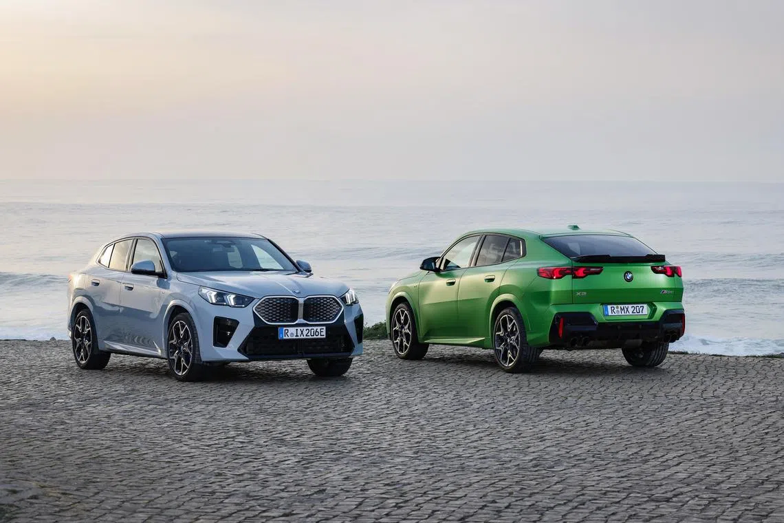 The green BMW X2 M35i is not a hybrid or electrified while the grey iX2 xDrive30 is a fully electric vehicle. 