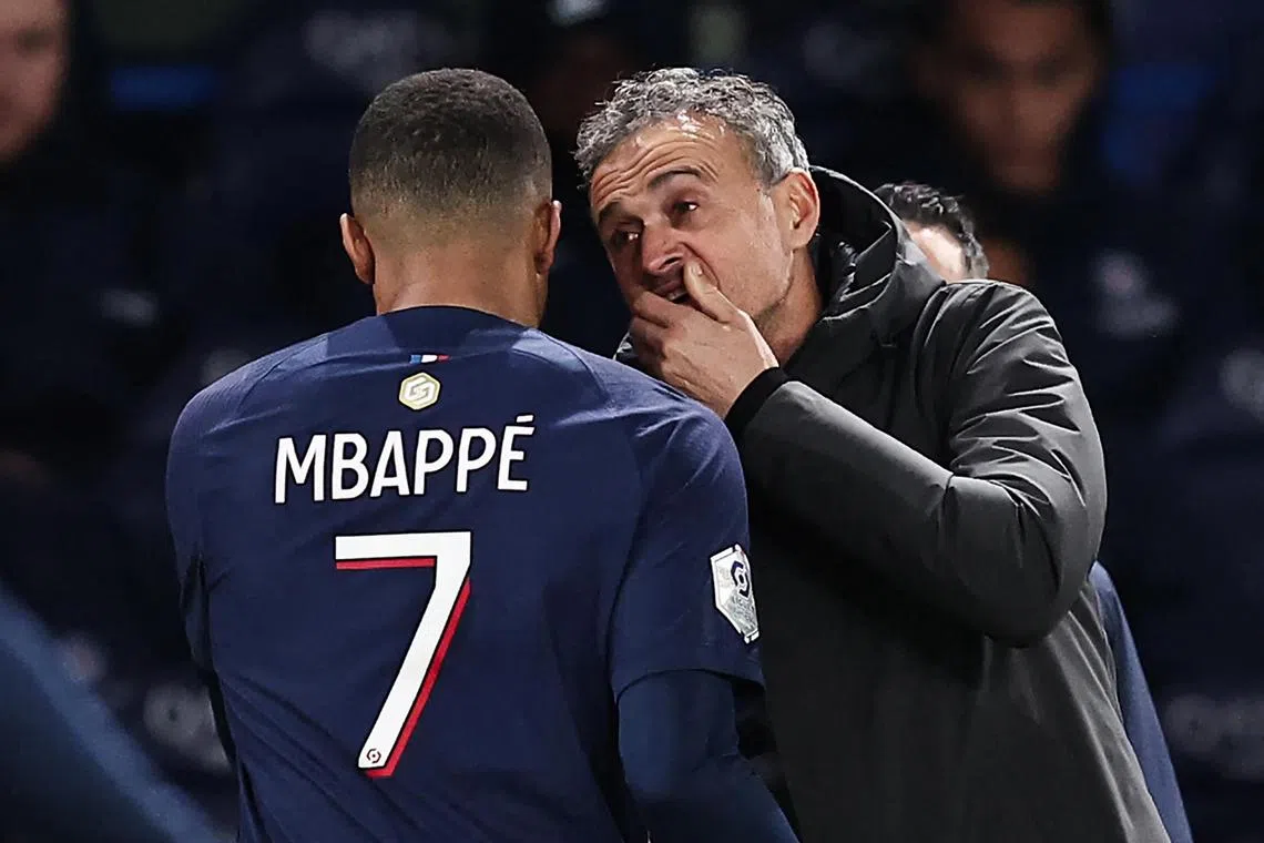 Paris Saint-Germain's French forward #07 Kylian Mbappe celebrates with Paris Saint-Germain's Spanish headcoach Luis Enrique after scoring his team's third goal during the French L1 football match between Paris Saint-Germain (PSG) and FC Metz at the Parc des Princes stadium in Paris, on December 20, 2023. Paris SG coach Luis Enrique's decision to take Kylian Mbappe off at half-time against Monaco on March 1, 2024, following two other matches in which the superstar was cut back, now comes three days before a crucial Champions League match. (Photo by FRANCK FIFE / AFP)