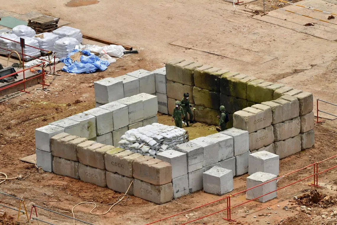 The Singapore Armed Forces (SAF) Explosive Ordnance Disposal team inspecting the site after the detonation of the bomb. The police said residents of The Linear, Hazel Park, Hazel Park Terrace houses, and those at Block 154 Gangsa Road, as well as shophouses in Upper Bukit Timah Road, must evacuate during the disposal operation from 8am to 7pm on Tuesday. Surrounding roads - the Bukit Panjang Flyover between Woodlands Road and Petir Road, and Upper Bukit Timah Road between Petir Road and Cashew Road - will also be closed from 11am to 7pm.