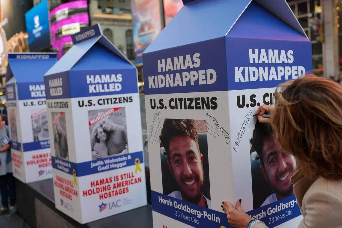 A person writes 'Murdered!' on a mock milk carton with the face of U.S. citizen Hersh Goldberg-Polin, who was kidnapped in the October 7 attack in Israel, amid the ongoing Israel-Hamas conflict, in New York City, U.S., October 7, 2024. REUTERS/Andrew Kelly/File Photo