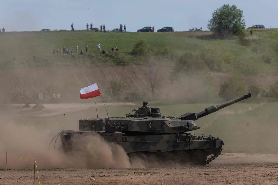 In this file photograph taken on May 19, 2022, a Polish Leopard tank manoeuvres as troops from Poland, USA, France and Sweden take part in the DEFENDER-Europe 22 military exercise, in Nowogrod, Poland. 