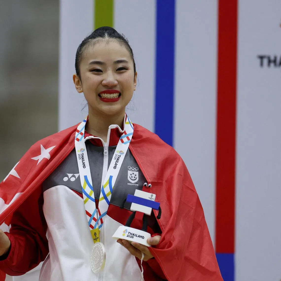 Southeast Asian Games - SEA - Gymnastics - Thammasat University Rangsit Campus, Pathum Thani, Thailand - December 16, 2025
Silver medallist Singapore's Mikayla Angeline Yang celebrates during the rhythmic gymnastics individual all around medal ceremony REUTERS/Chalinee Thirasupa