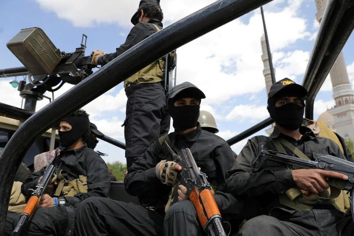 FILE PHOTO: Houthi policemen ride on the back of a patrol pick-up truck during the funeral of Houthi fighters killed in U.S.-led strikes, in Sanaa, Yemen February 10, 2024. REUTERS/Khaled Abdullah