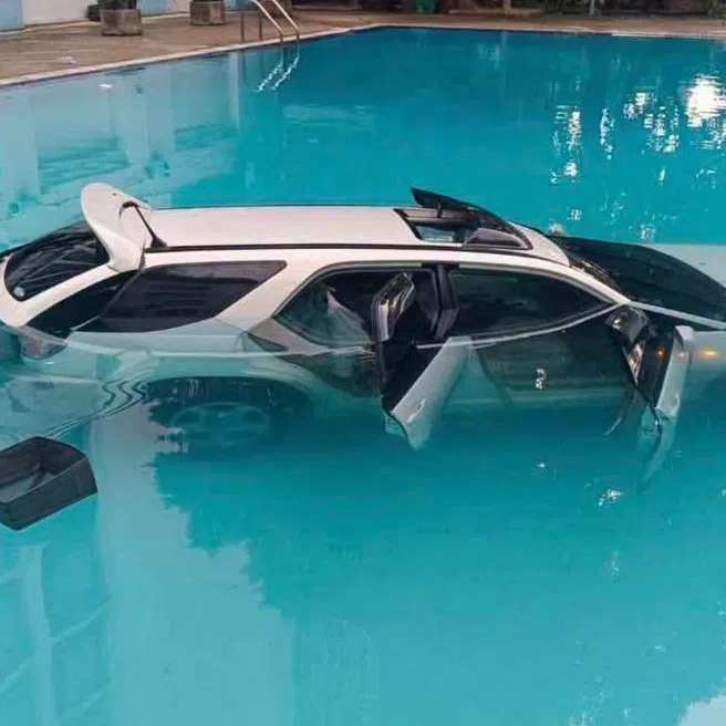 Images online show the white Toyota Harrier nearly submerged in a swimming pool at Chulalongkorn University in central Bangkok.