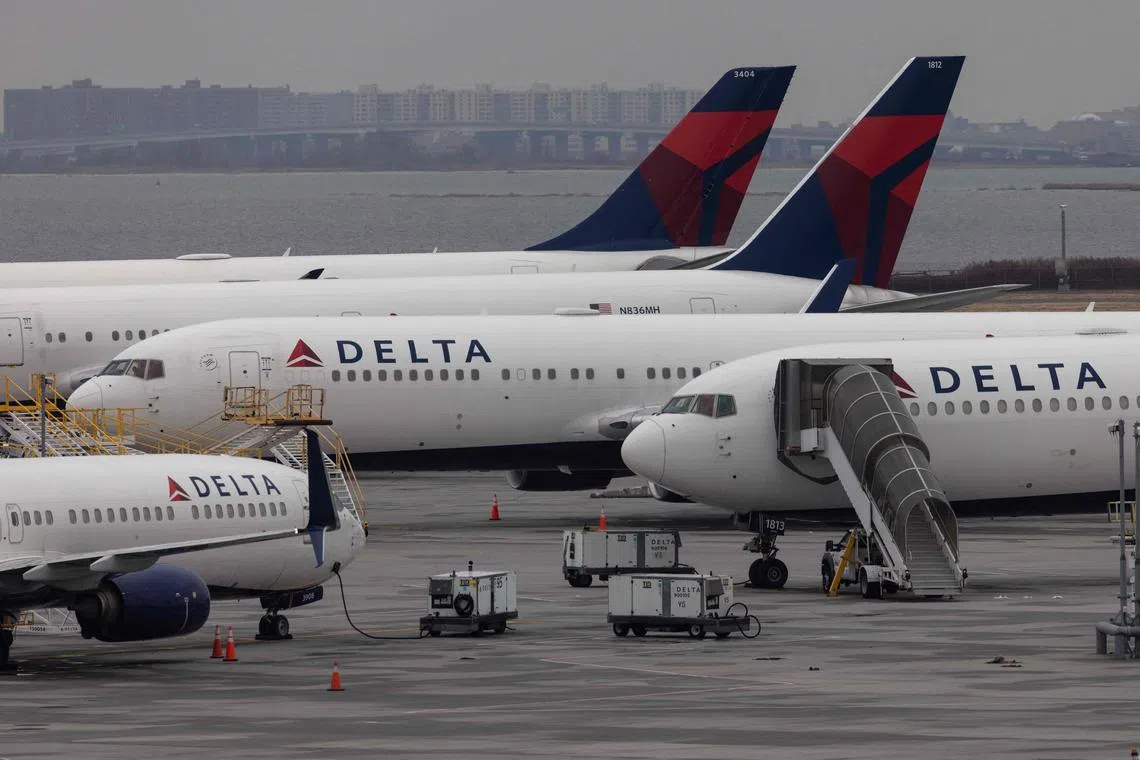 (FILES) In this file photo taken on December 24, 2021, Delta Airlines passenger aircrafts are seen on the tarmac of John F. Kennedy International Airpot in New York. - Pointing to persistently strong flying demand, Delta Air Lines offered a bullish spring season forecast on April 13, 2023, as it reported a loss in the first quarter. The big US carrier, the first major airline to report results, described robust bookings across the board, with both international and business travel adding to earlier recoveries in domestic leisure. (Photo by Yuki IWAMURA / AFP)