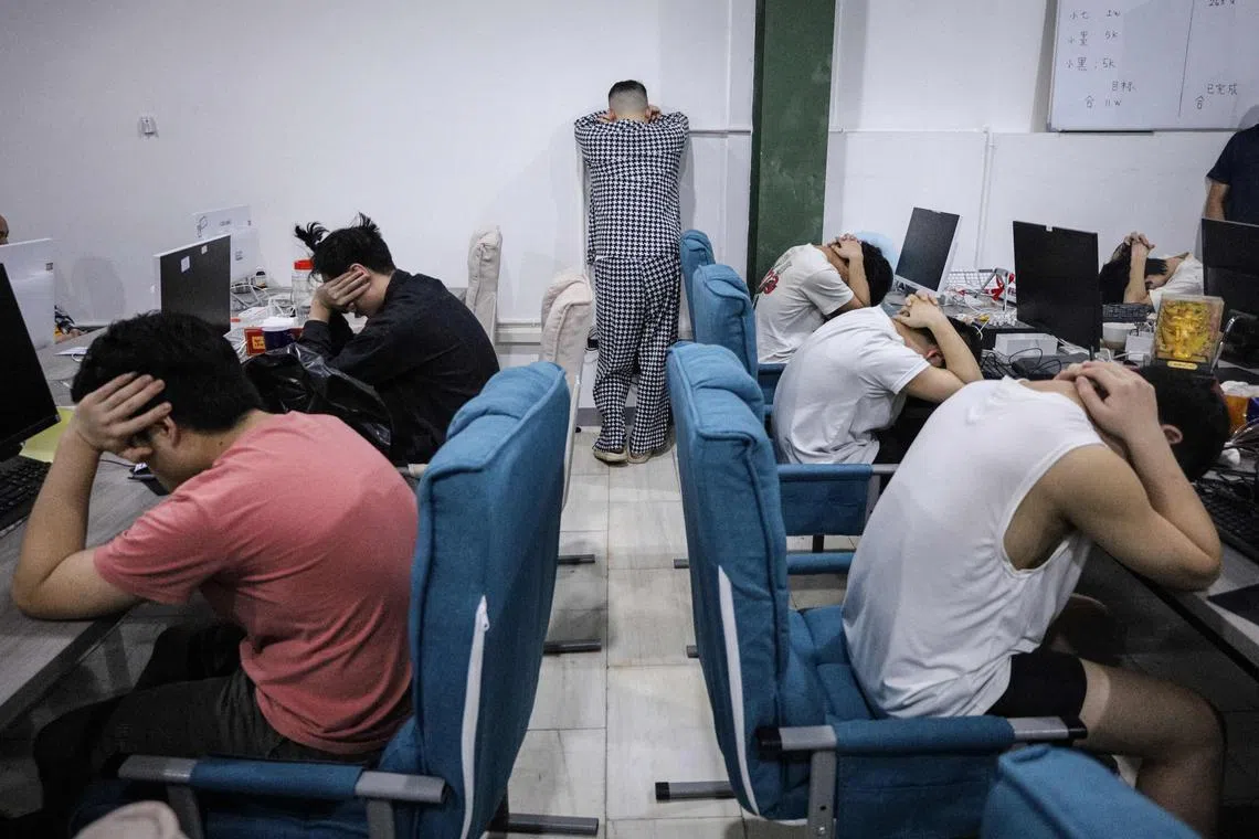 A group of Chinese nationals arrested during a police raid on suspicion of running an online love scam syndicate at a building of the Kara Industrial Park in Batam, on August 29, 2023.