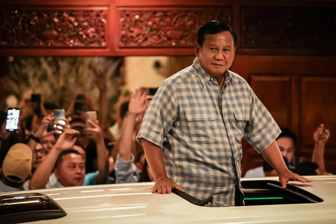 Indonesian presidential candidate Prabowo Subianto reacts to supporters from a car as he leaves from his residence to attend a gathering with supporters after polls closed in the country's presidential and legislative elections in Jakarta on February 14, 2024. Indonesian Defence Minister Prabowo Subianto was on course to win the archipelago's presidential election by a wide margin, election commission results showed on February 16, with 50 percent of votes counted. (Photo by Yasuyoshi CHIBA / AFP)