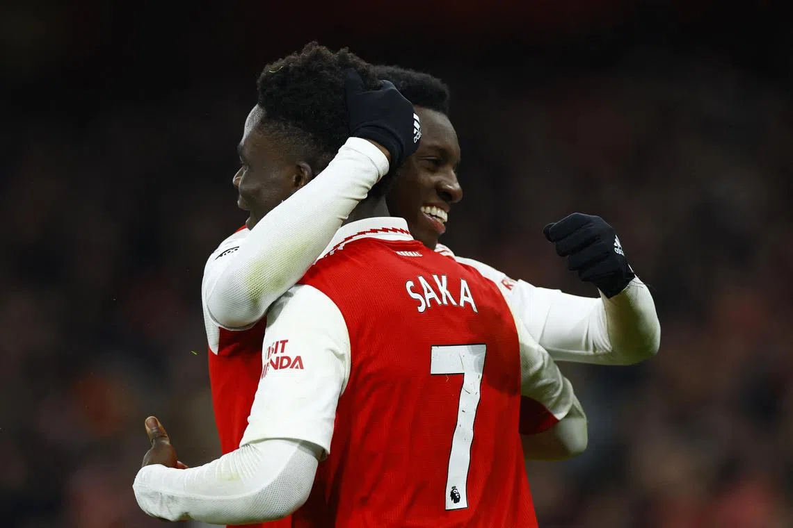 Arsenal's Eddie Nketiah celebrates scoring the winning goal for his team, with teammate Bukayo Saka.