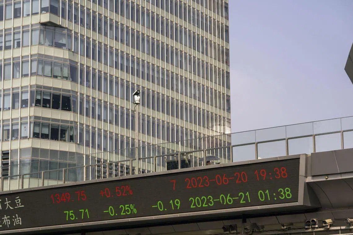 An electronic ticker displays stock figures in Pudong's Lujiazui Financial District in Shanghai, China, on Wednesday, June 21, 2023. China's yuan weakened past the closely watched 7.2-per-dollar level as investor sentiment soured on a lack of aggressive stimulus and Beijing signaled a level of comfort about the declines. Photographer: Raul Ariano/Bloomberg