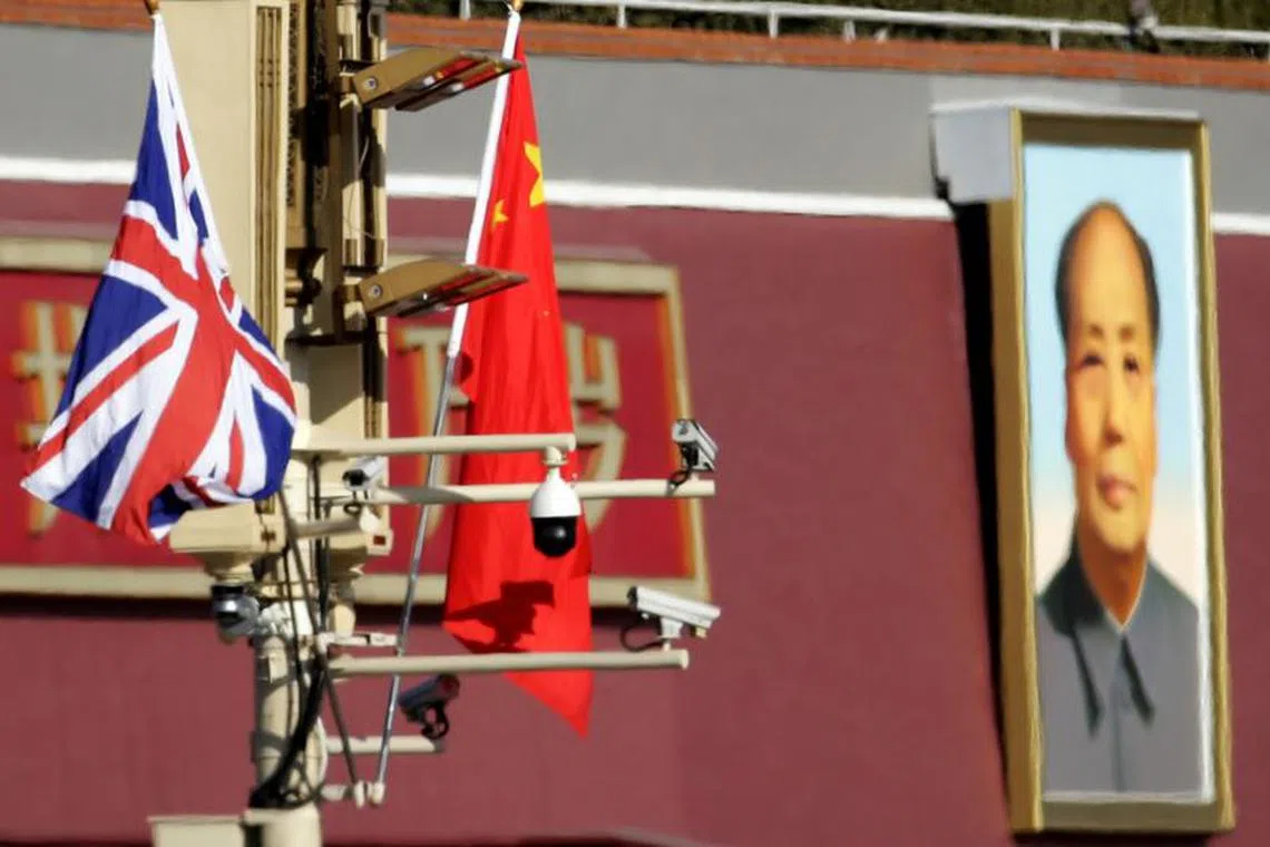 A Union flag and a Chinese flag are placed at a pole with security cameras in front of a portrait of late Chinese Chairman Mao Zedong at the Tiananmen gate during a visit by British Prime Minister Theresa May to China, in Beijing, January 31, 2018. REUTERS/Jason Lee/File photo