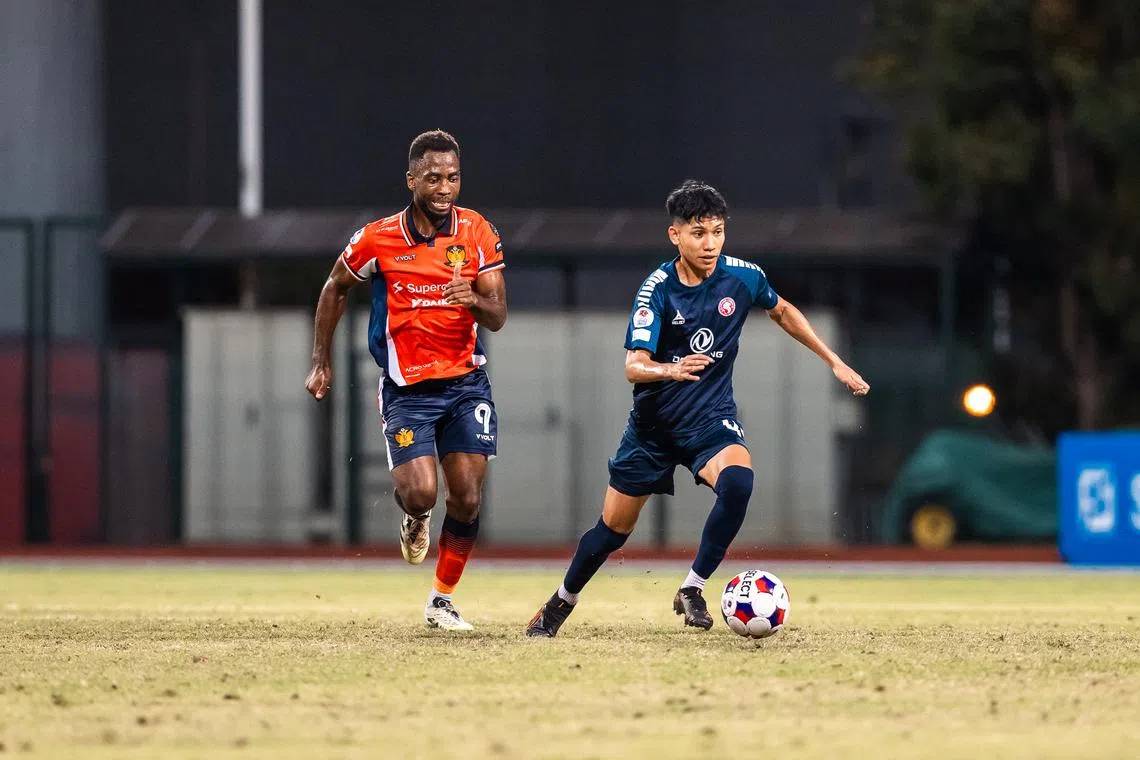 Gloire Amanda (left) in action for Hougang United in the Singapore Premier League in a match against the Young Lions on Jan 30. 