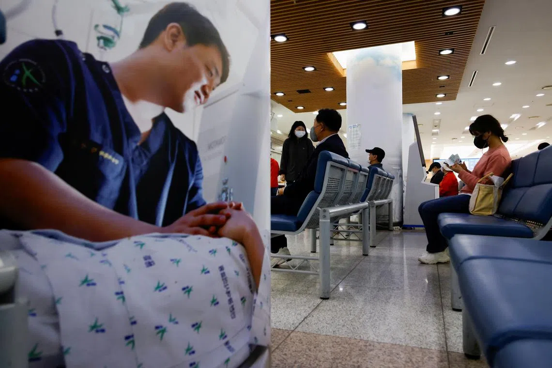 FILE PHOTO: People sit as they wait at the Incheon Medical Center in Incheon, South Korea, April 23, 2024. REUTERS/Kim Soo-hyeon/File Photo