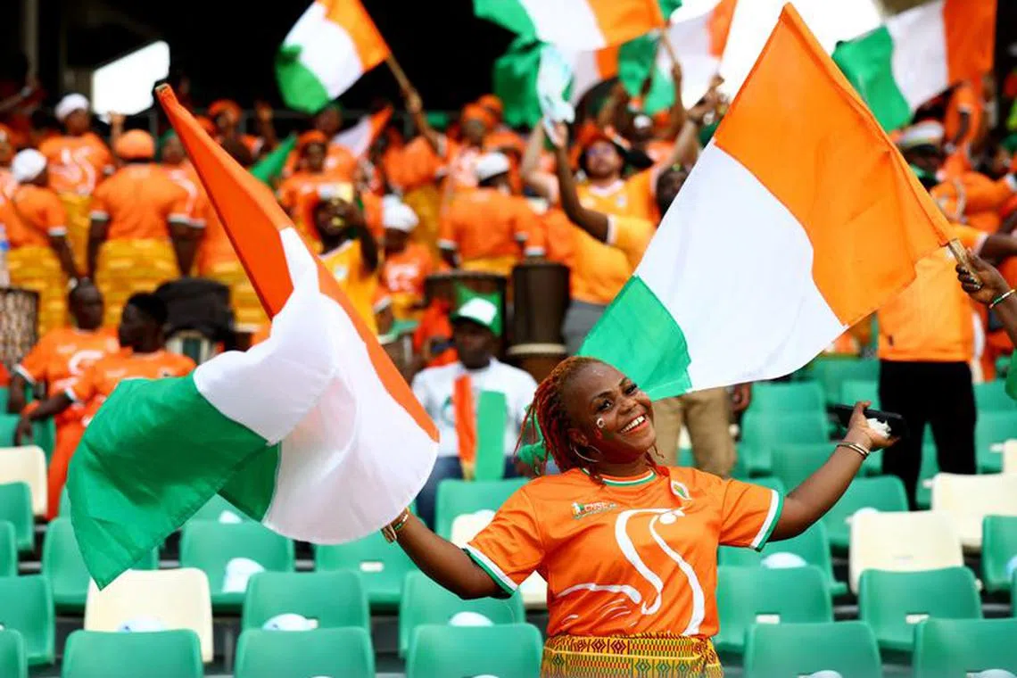 Soccer Football - Africa Cup of Nations - Final - Nigeria v Ivory Coast - Stade Olympique Alassane Ouattara, Abidjan, Ivory Coast - February 11, 2024 Ivory Coast fan with a flag inside the stadium before the match REUTERS/Siphiwe Sibeko