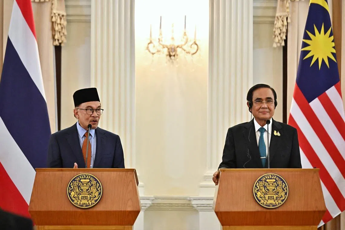 Malaysia's PM Anwar Ibrahim (left) and Thailand's PM Prayut Chan-O-Cha during an official state visit at Government House in Bangkok on Feb 9, 2023. 