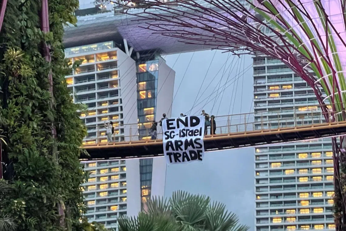 The three protesters can be seen in a video clip standing on the OCBC Skyway and unfurling a banner.