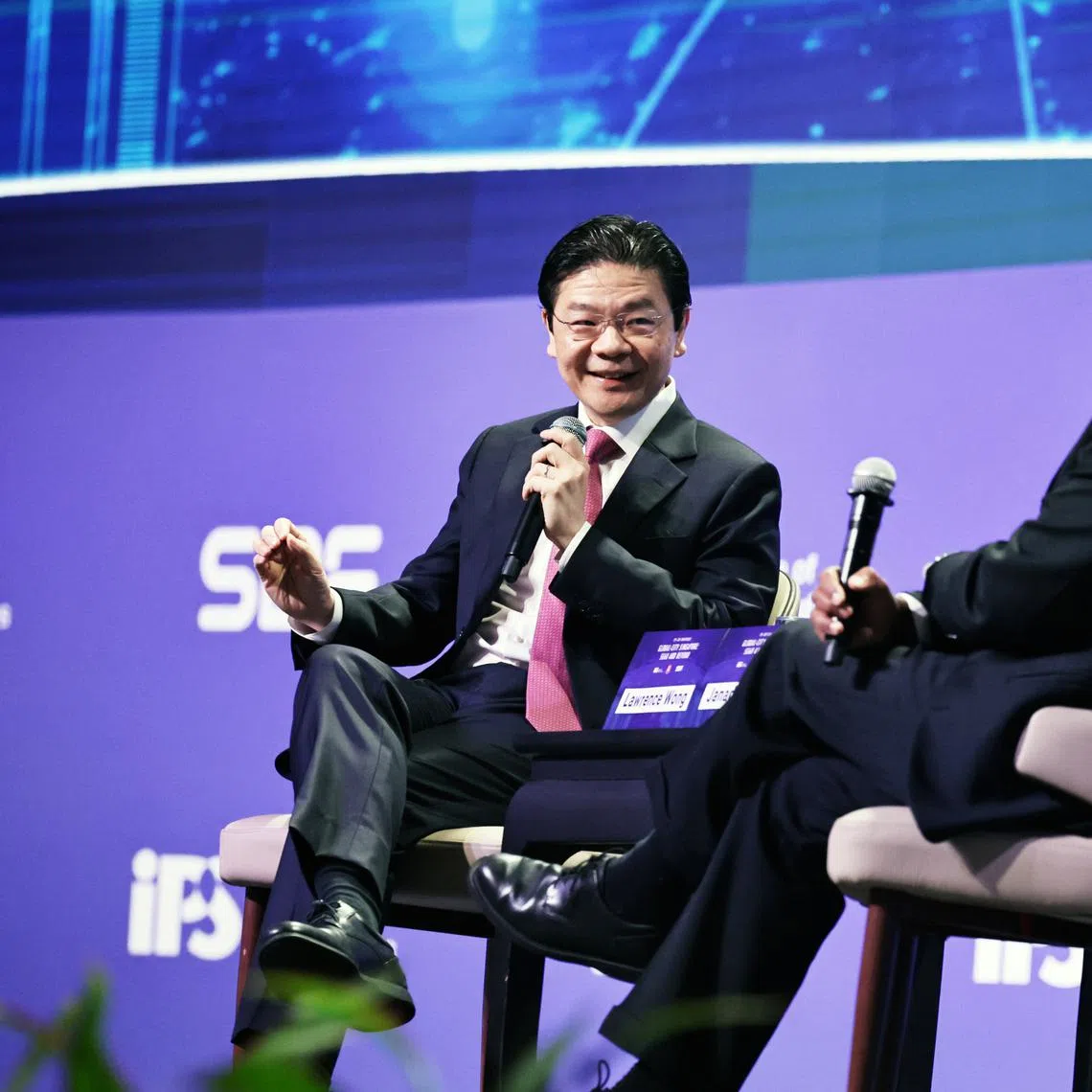 Prime Minister Lawrence Wong speaks during a dialogue moderated by IPS director Janadas Devan on July 29.