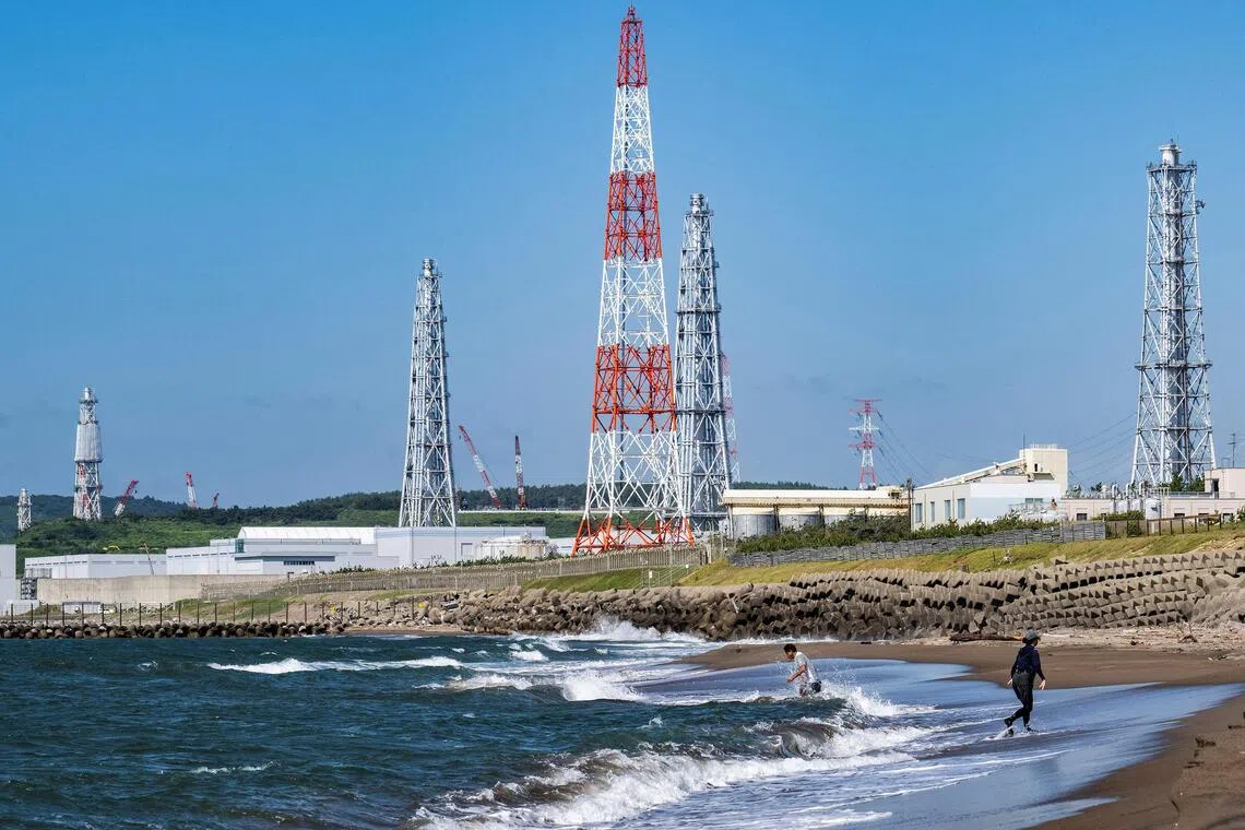 People visiting Arahama beach in front of the Kashiwazaki-Kariwa nuclear power station in Kashiwazaki, in Japan's Niigata prefecture, on Aug 5, 2024.