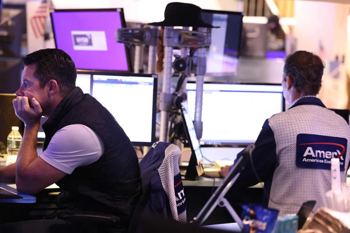 Traders work on the floor of the New York Stock Exchange, in New York City. 