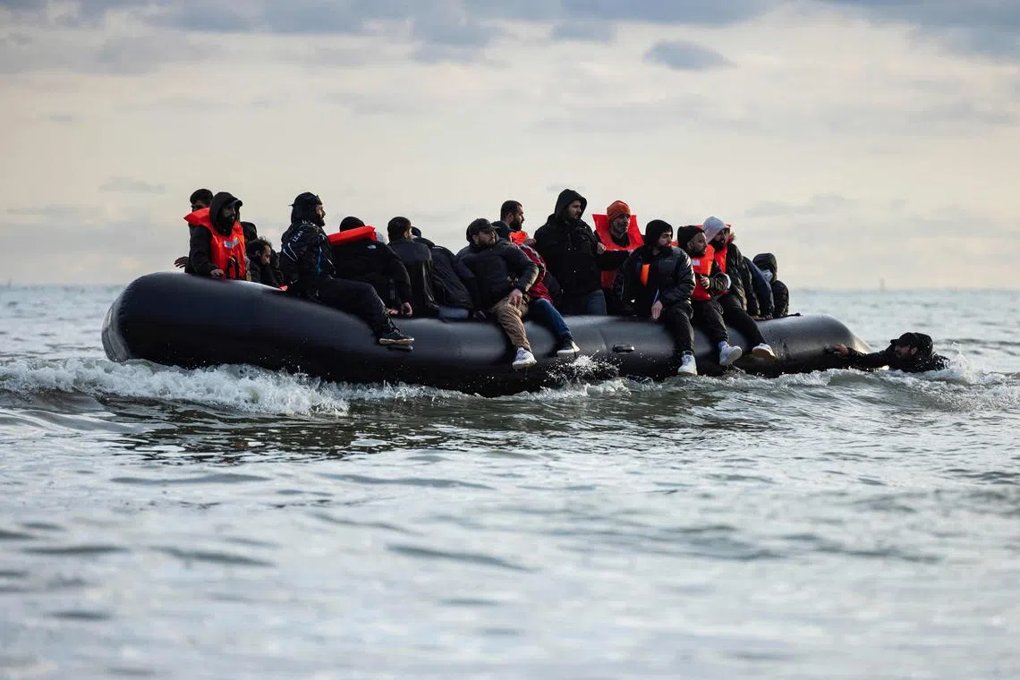 Migrants board a smuggler's boat in an attempt to cross the English Channel, on the beach of Gravelines, near Dunkirk, northern France on April 26.