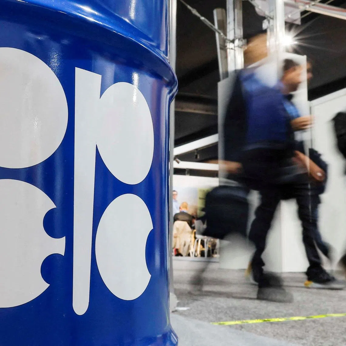 FILE PHOTO: People walk past an installation depicting barrel of oil with the logo of Organization of the Petroleum Exporting Countries (OPEC) during the COP29 United Nations climate change conference in Baku, Azerbaijan November 19, 2024. REUTERS/Maxim Shemetov/File Photo