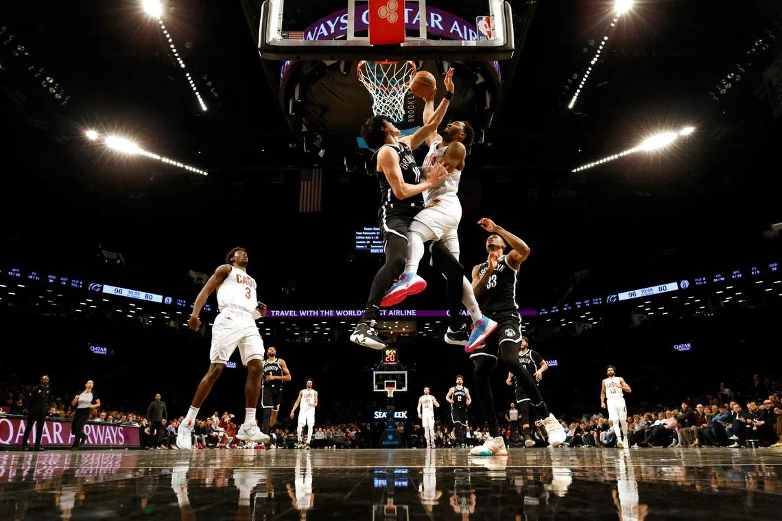 Donovan Mitchell of the Cleveland Cavaliers dunks against Yuta Watanabe of the Brooklyn Nets during their game at Barclays Centre.