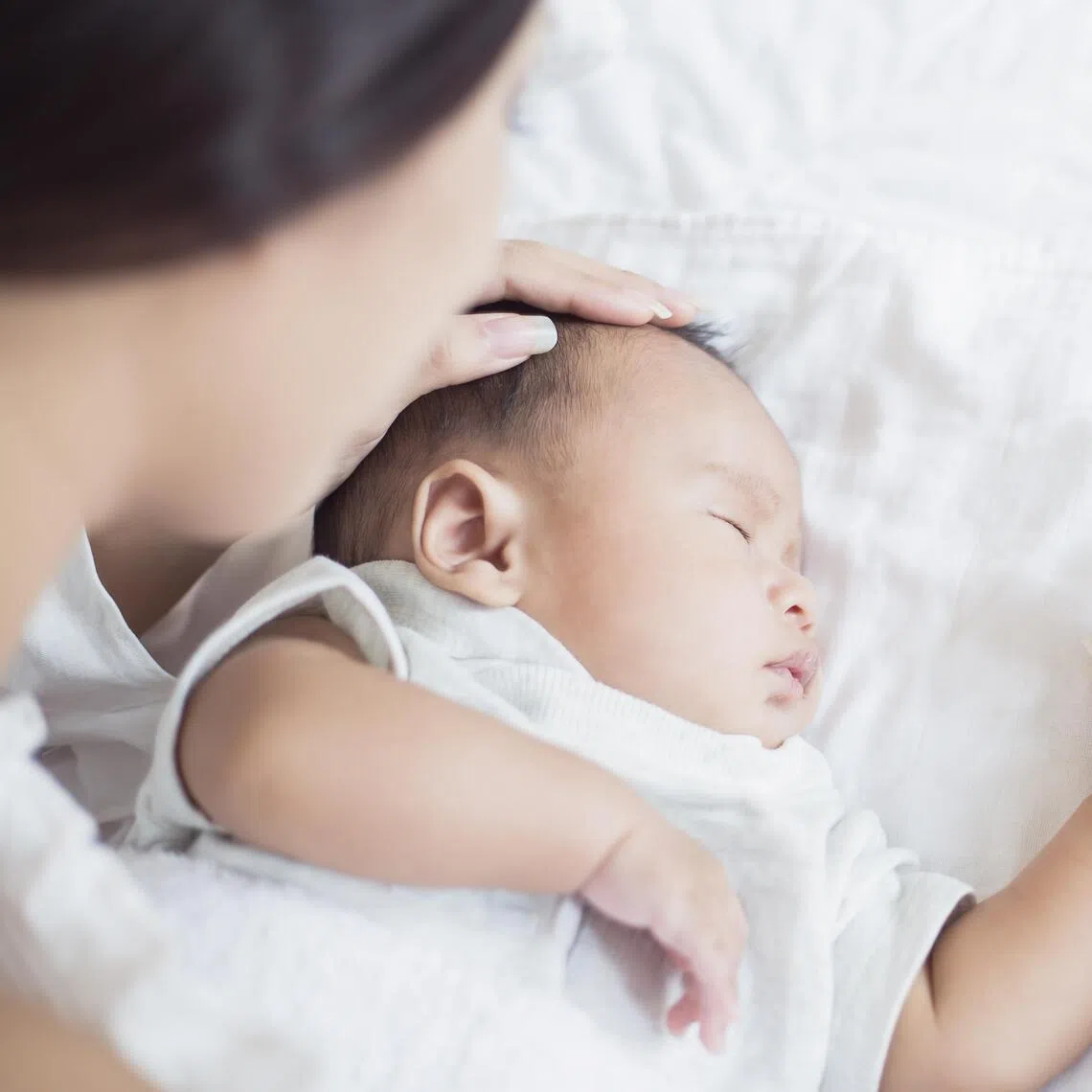 Mother Checks The Temperature Of A Sick Baby, newborn baby had a fever. Healthcare medical motherâs day concept.