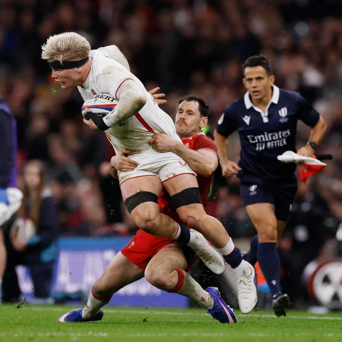 England's Henry Pollock being tackled by Wales' Tomos Williams during the 48-7 rout of Wales in the Six Nations on Feb 7, 2026 at Twickenham.