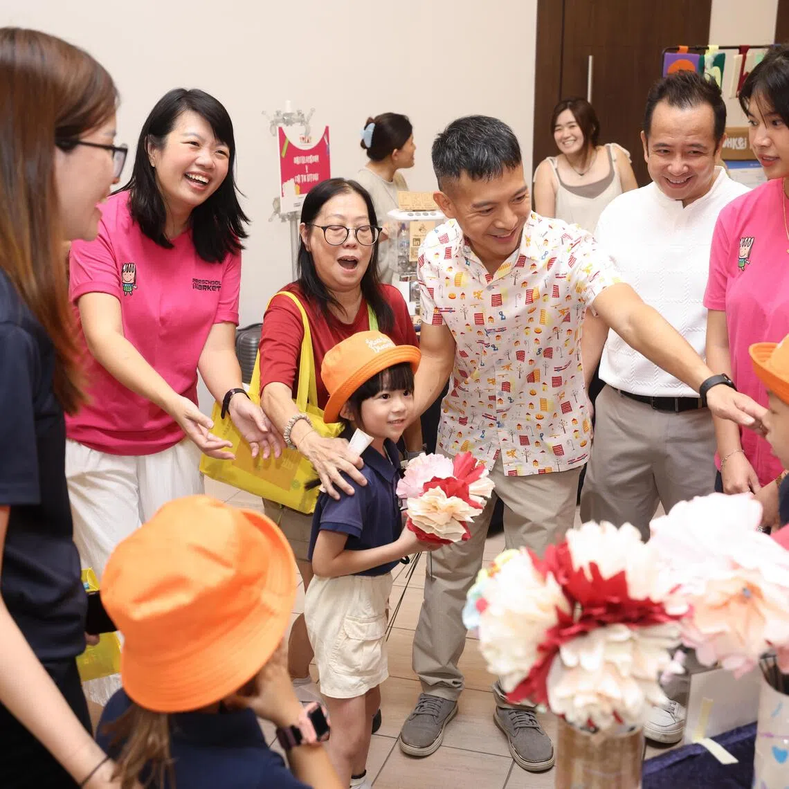 Children giving flowers to MP for Jalan Besar GRC Shawn Loh together with Preschool Market founder Cheong Su Fen at an appreciation event on Aug 29.