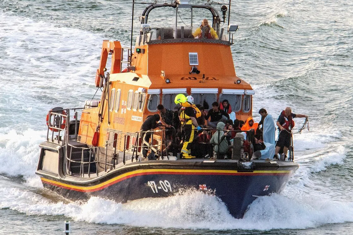 FILE PHOTO: Rescue personnel bring migrants ashore, after a boat carrying migrants from France sunk in the English Channel, in Dover, Britain August 12, 2023, in this still image obtained from social media. Stuart Brock/via REUTERS/File Photo
