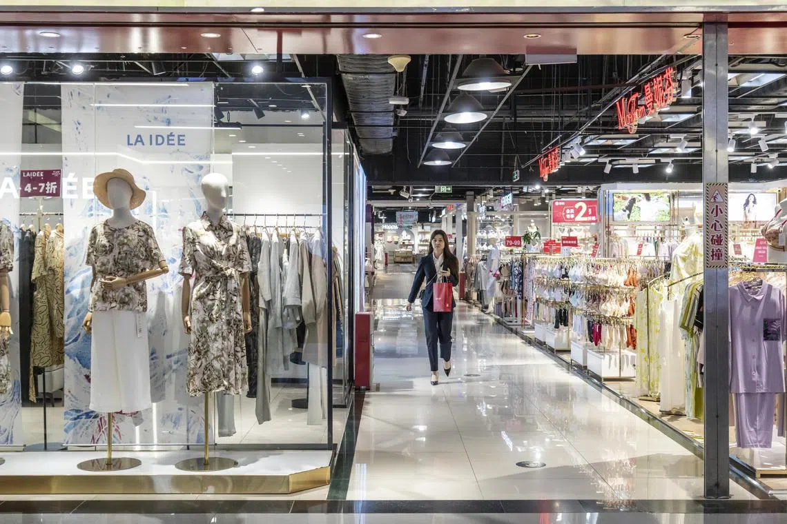 People walk through an outlet mall that was nearly empty of shoppers in Guangzhou, April 7.