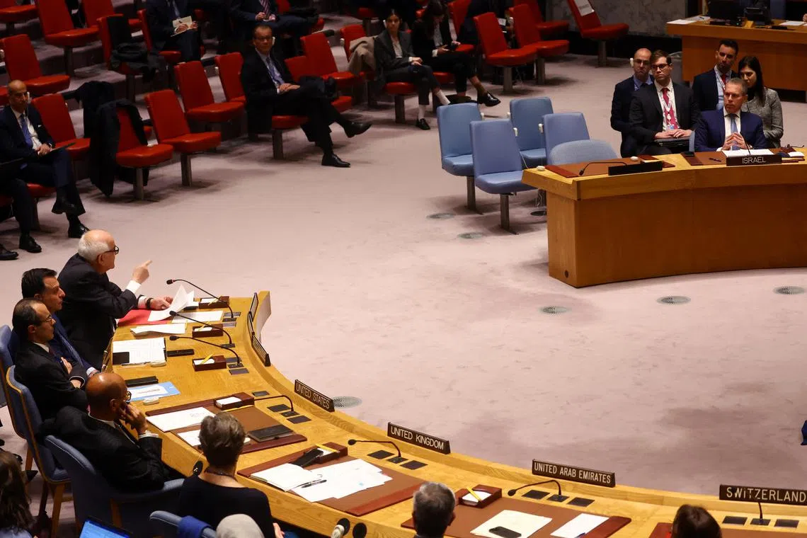 Riyad Mansour, Permanent Observer of Palestine to the UN, speaks as Israel's Ambassador Gilad Erdan looks during a UN Security Council meeting to discuss recent developments at the Al Aqsa mosque compound.