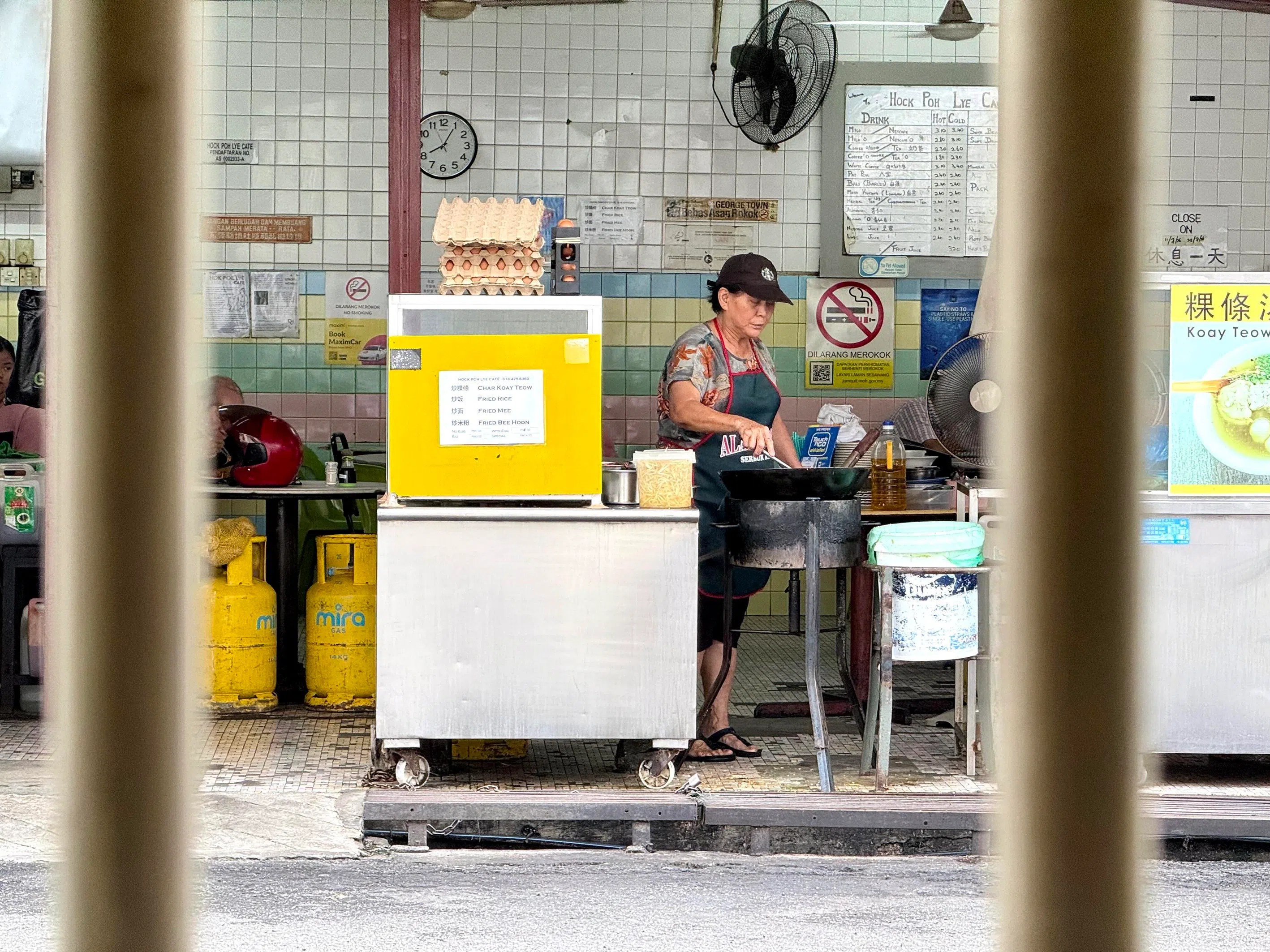 A George Town hawker frying Penang’s famous char koay teow early across from Ren I Tang, a boutique hotel which uses the Mandarin phonetic spelling of Yin Oi Tong, South-east Asia’s oldest Chinese medical hall wholesaler which was established in 1796. Yin Oi Tong moved from the site to faciliate a restoration in 2009 and is now located in the nearby suburb of Ayer Itam.