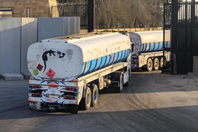 Trucks carrying fuel enter the crossing into the Gaza Strip at the Rafah border on the Egypt side on Oct 17.