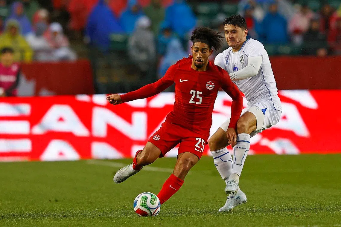 Jun 1, 2026; Edmonton, Ontario, CAN; Team Canada midfielder Nathan Saliba (25) makes a pass in front of Uzbekistan defender Abdukodir Khusanov (2) during the second half at Commonwealth Stadium. Mandatory Credit: Perry Nelson-Imagn Images