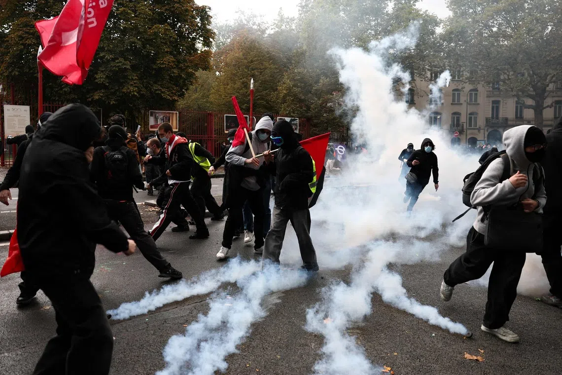 Protesters walk among tear gas during a demonstration to protest against high cost of living, in Lille, northern France, on Oct 17, 2026.