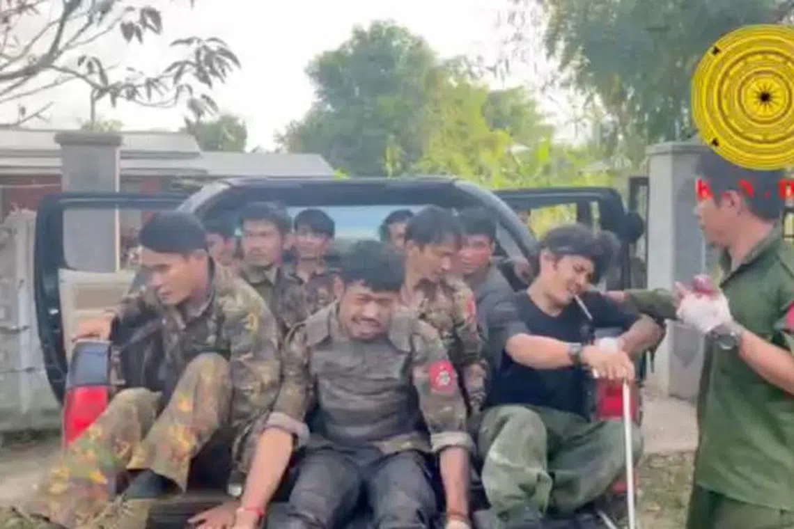 Myanmar military soldiers who have surrendered to the Karenni Nationalities Defense Force ride in the back of a vehicle in Loikaw, Myanmar, in this still image taken from video released November 15, 2023.     Karenni Nationalities Defense Force/Handout via REUTERS