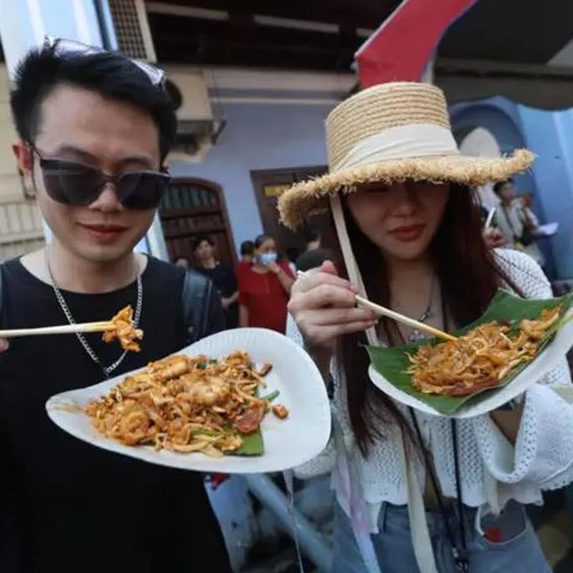 Visitors to the char kway teow competition on June 1 sampling some of the offerings.